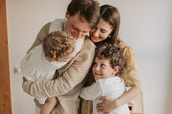 Family embracing together, representing wealth planning strategies focused on legacy, lifestyle, and long-term financial goals