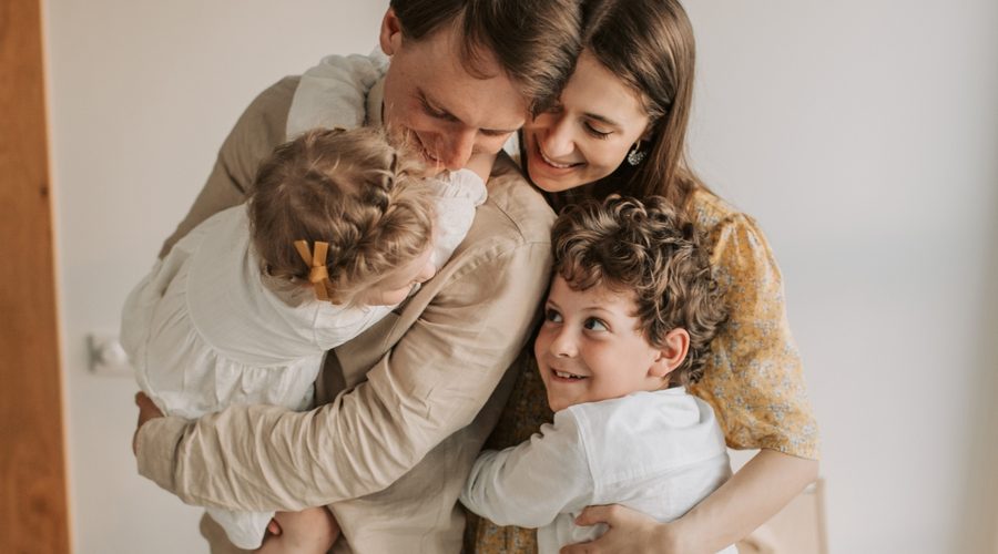Family embracing together, representing wealth planning strategies focused on legacy, lifestyle, and long-term financial goals